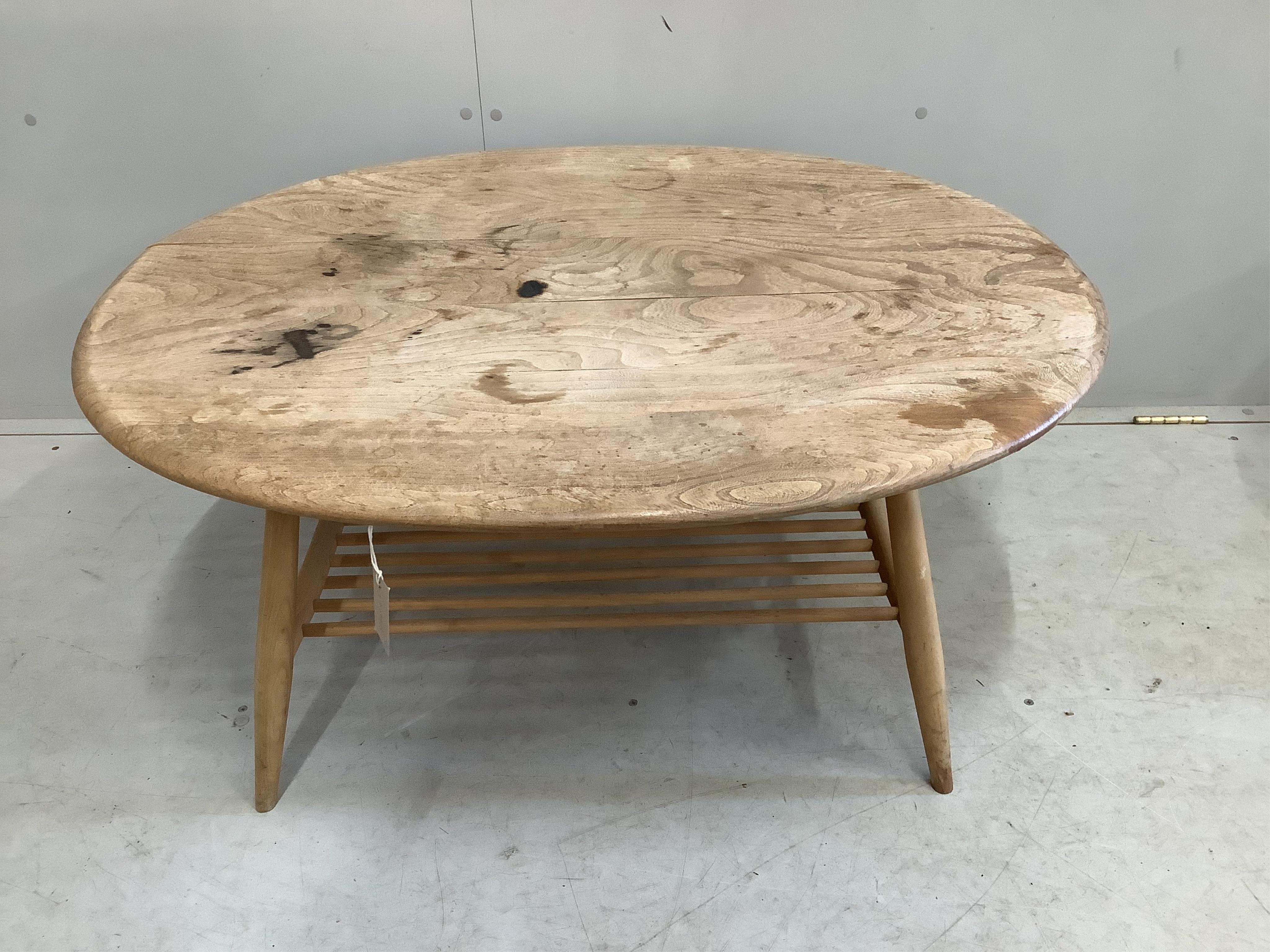 An Ercol oval elm coffee table and a nest of two tables, largest width 98cm, depth 84cm, height 44cm. Condition - poor